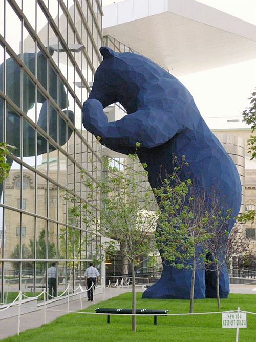 скульптура медведя, заглядывающего в окна 